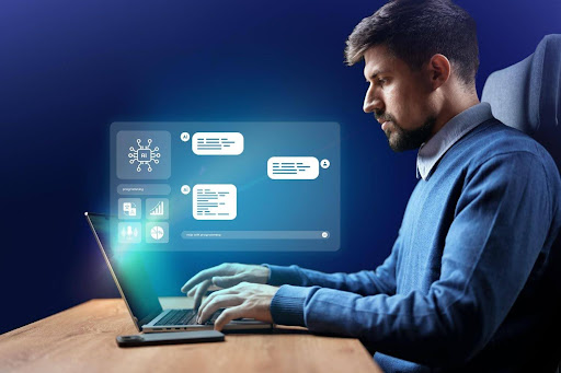 Male human working on his laptopt witha CRM being displayed.